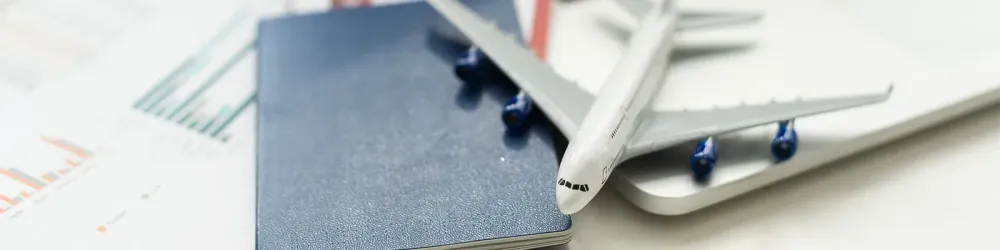 Close up concept of toy plane on a pile of passports and boarding passes